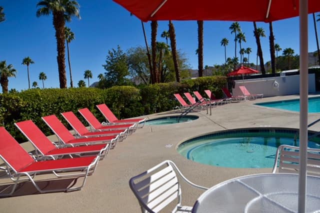 Poolside lounge chairs beside the spa